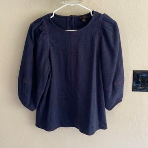 Soft top with puffed sleeves. Cute button back.